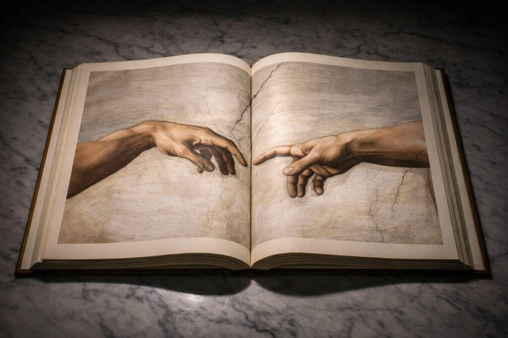 Il significato nome Adamo nell'arte: il dettaglio delle mani della Creazione di Adamo di Michelangelo su un libro d'arte